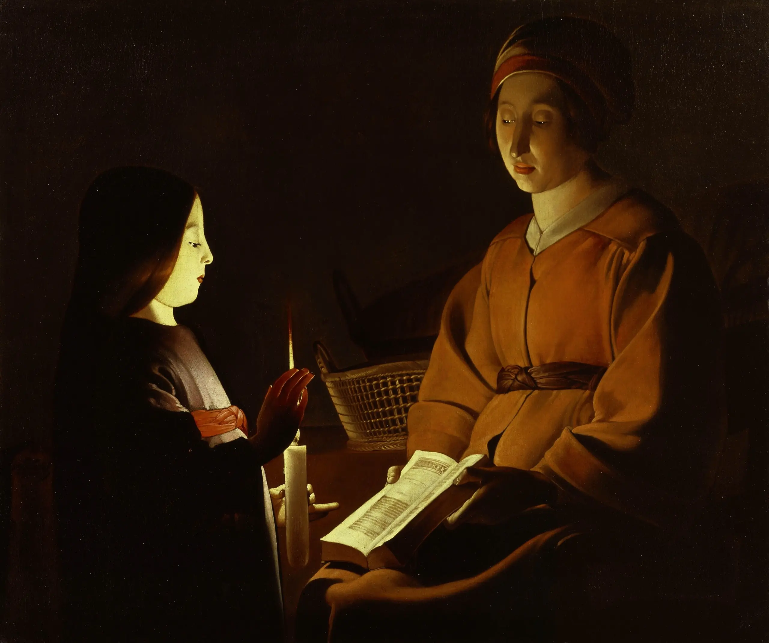 In a darkened room, Saint Anne sits holding an open book while the child Mary stands reading beside her; Mary shields a lit candle with her hand, and its flame glows through her fingers and lights both faces.